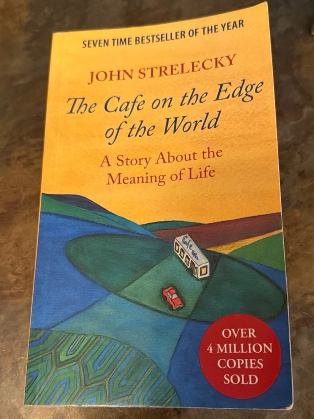The Cafe on the Edge of the World - Yellow Cover paperback book